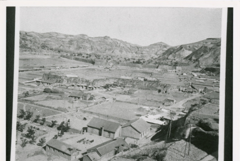 Aerial view of buildings and hills (ddr-densho-1007-186)