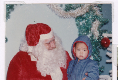 Mark Isoshima sitting on Santa Claus knee (ddr-densho-477-342)
