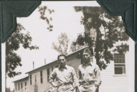 Two men standing in grass outside building.  Joe Iwataki on right (ddr-ajah-2-416)
