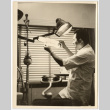 Dentist examining x-rays (ddr-densho-542-799)