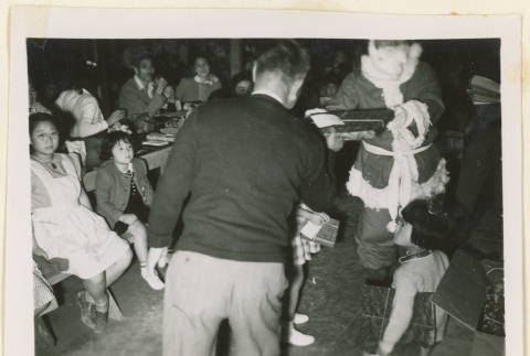 Santa Claus handing out gifts (ddr-densho-37-1303)
