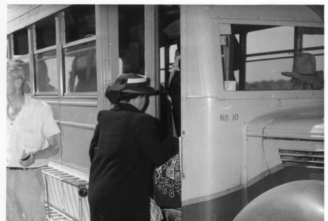 A woman boarding a bus to go to Minidoka (ddr-fom-1-888)