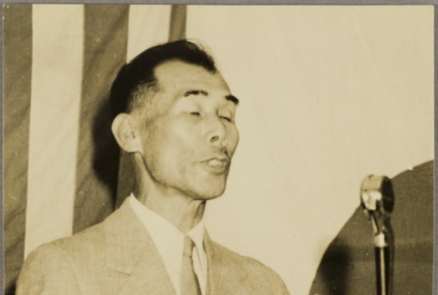 Eisaku Honda speaking into a microphone (ddr-njpa-5-1304)