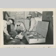 Three workers at baggage inspection (ddr-densho-37-887)