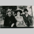 A woman and two men sitting together outside (ddr-densho-353-219)
