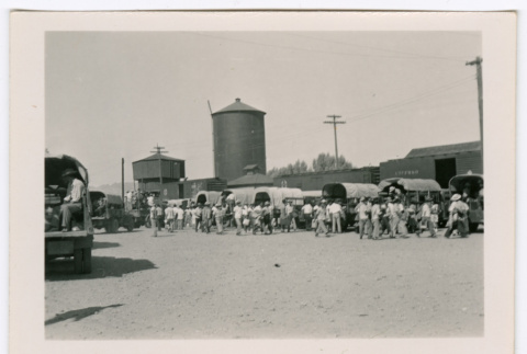 People loading into the beds of trucks (ddr-densho-475-387)