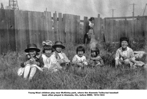 Group of children sitting in grassy yard (ddr-ajah-6-577)