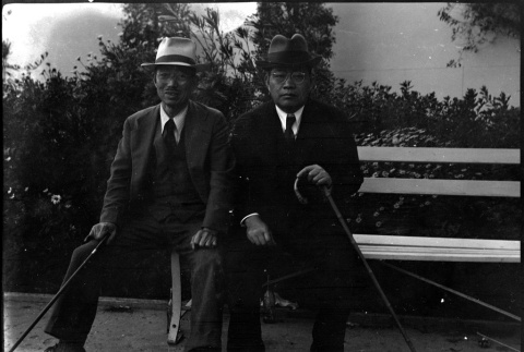 Tomoyuki and unknown man seated on bench (ddr-densho-426-1734)
