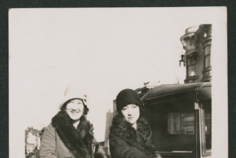 two women standing next to a car (ddr-densho-378-765)