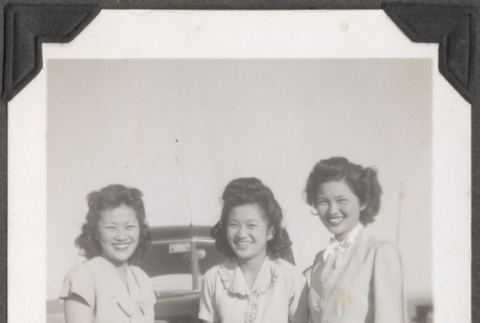 Three women standing by car (ddr-densho-466-212)