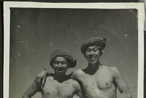 Two Japanese American soldiers in swimming trunks on a beach (ddr-densho-201-397)