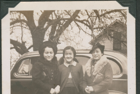 Three women next to car (ddr-densho-316-361)