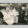 Boy and baby by Christmas tree (ddr-densho-523-87)