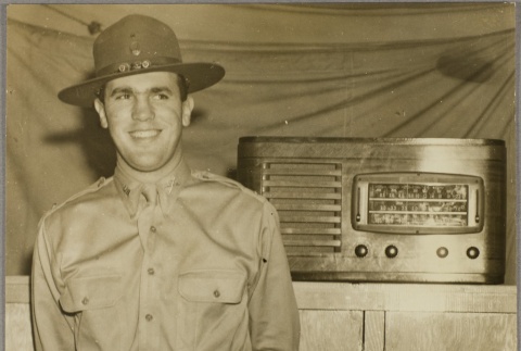 Man standing by a radio (ddr-njpa-5-851)
