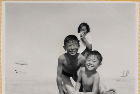 Woman and two boys playing on beach (ddr-densho-522-287)