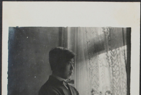 Gentaro Takahashi standing by window (ddr-densho-355-606)