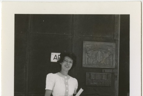 Woman standing outside a building (ddr-manz-7-105)