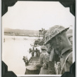 Men in uniform alongside boats (ddr-ajah-2-165)