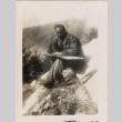 Man sitting on rocky hillside (ddr-densho-466-281)