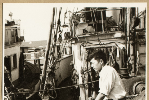 Man seated on a fishing boat (ddr-densho-542-789)