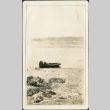 A man leaning into a row boat (ddr-densho-321-646)