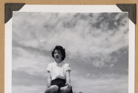 Ruth (Saitow) Kikawa seated on a sand dune (ddr-densho-542-345)