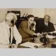A group of men wearing headphones at a table (ddr-njpa-2-864)