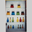 Display of colored glass bottles and jars (ddr-densho-426-1205)