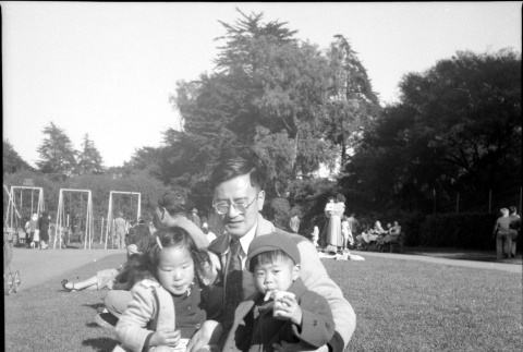 Man sitting with park with Masako and Norman Takahashi (ddr-densho-426-928)