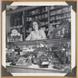 Woman standing behind a glass case (ddr-densho-542-107)