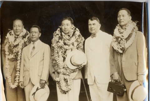 John H. Wilson posing with men wearing leis (ddr-njpa-2-909)