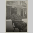 Japanese American soldier sitting in a plaza (ddr-densho-201-200)