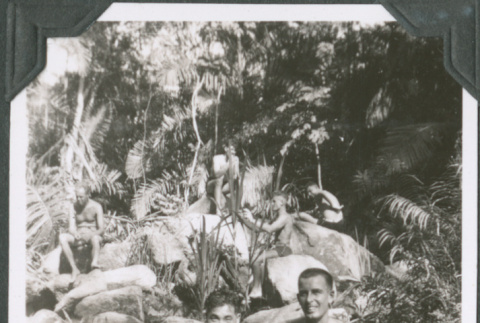 Two men sitting on rocks in swim trunks (ddr-ajah-2-639)