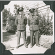 Joe Iwataki and Tsunch Inouye in uniform standing outside building (ddr-ajah-2-147)
