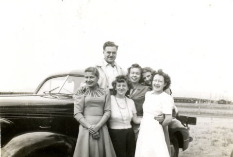 Group photo by car (ddr-csujad-26-111)