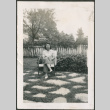Woman sitting in chair in garden (ddr-densho-316-401)