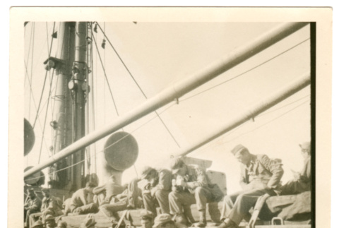 Soldiers sitting on deck of ship (ddr-densho-368-31)