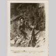 Man with rifle smoking a pipe (ddr-densho-466-296)