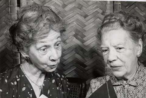 Two women looking at a Honolulu Symphony brochure (ddr-njpa-2-567)