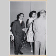 Three people at cocktail party (ddr-densho-522-129)