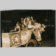 Three women in parade car with flag with 14 stars (ddr-densho-426-2085)