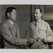 Robert C. Richardson holding a piece of paper with another man (ddr-njpa-1-1415)