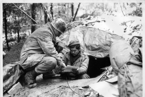 Nisei soldier discussing enemy position (ddr-densho-114-17)