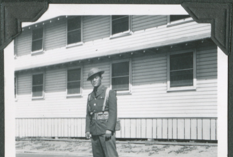 Man in uniform standing outside building (ddr-ajah-2-74)