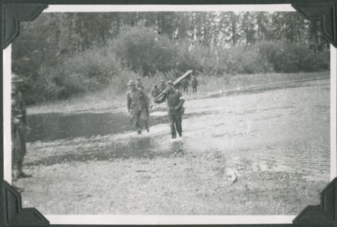 Two  men in uniform crossing a shallow creek (ddr-ajah-2-239)