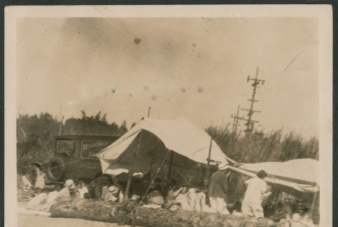 Photo of people gathered under a canvas tent (ddr-densho-483-928)