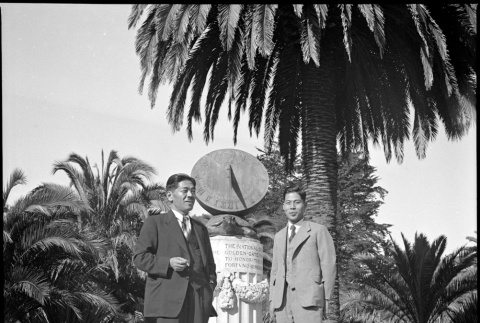 Two men standing by sun dial (ddr-densho-426-1636)