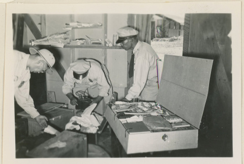 Three workers at baggage inspection (ddr-densho-37-887)