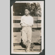 boy leaning against a fence (ddr-densho-378-536)