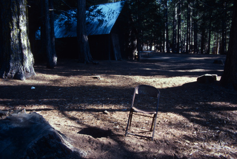 An empty folding chair in camp (ddr-densho-336-1501)